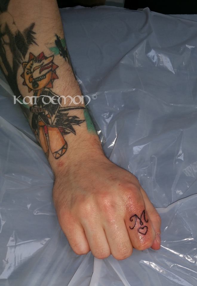 finger tattoo M